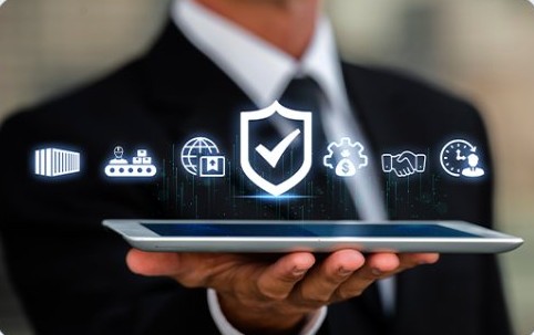 Business professional holding a tablet with a security shield